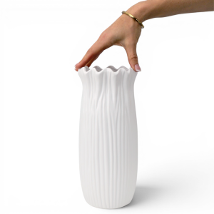 Hand resting across the frilled rim of the Short Marissa White Vase to show its scale